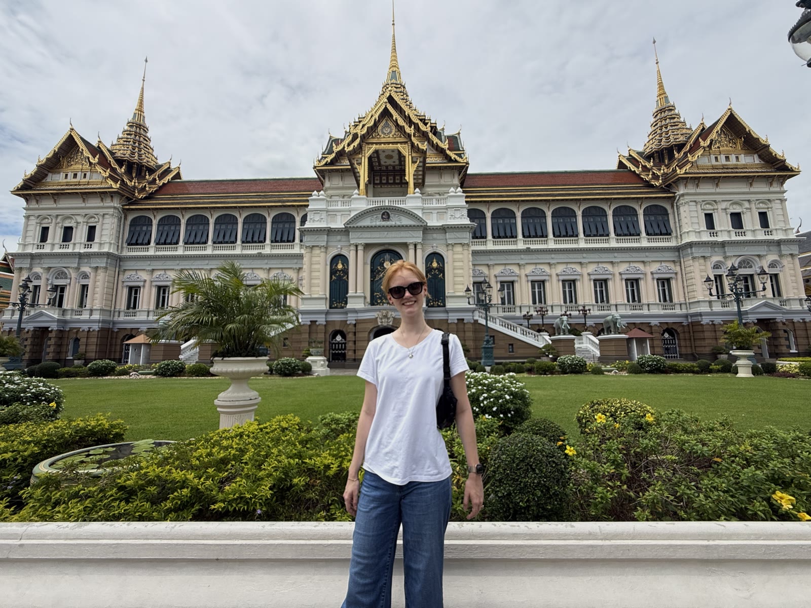 Anastasia standing in front of a palace building in Bangkok